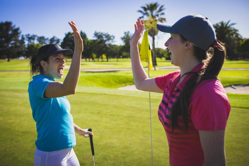 Start Here Begin Your Golf Journey With Confidence, image of female golfers high fiving